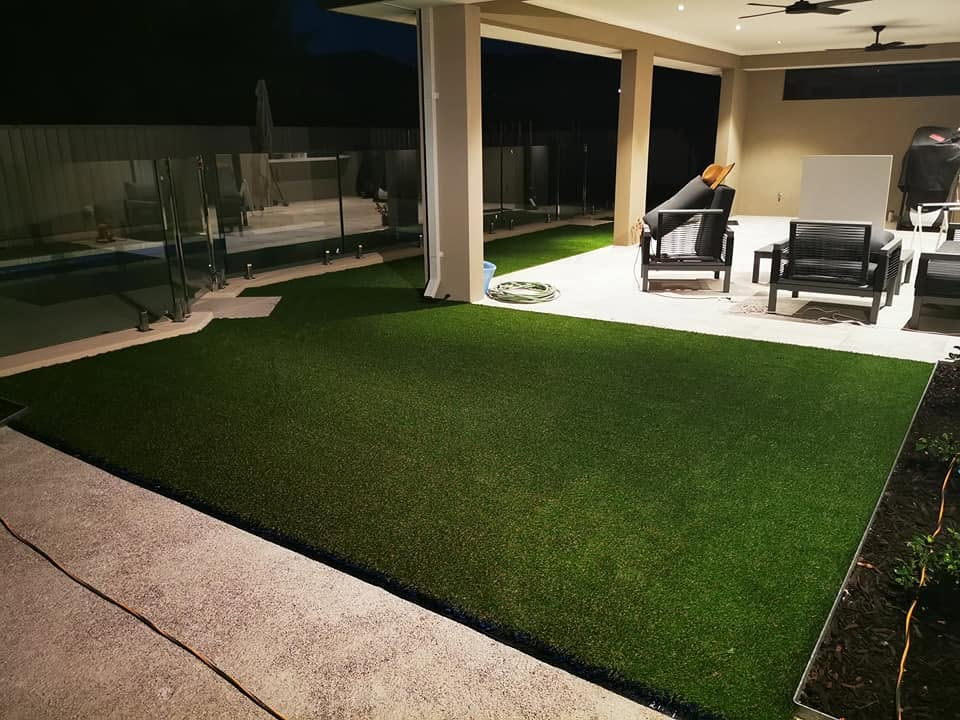 Poolside synthetic turf lit at night